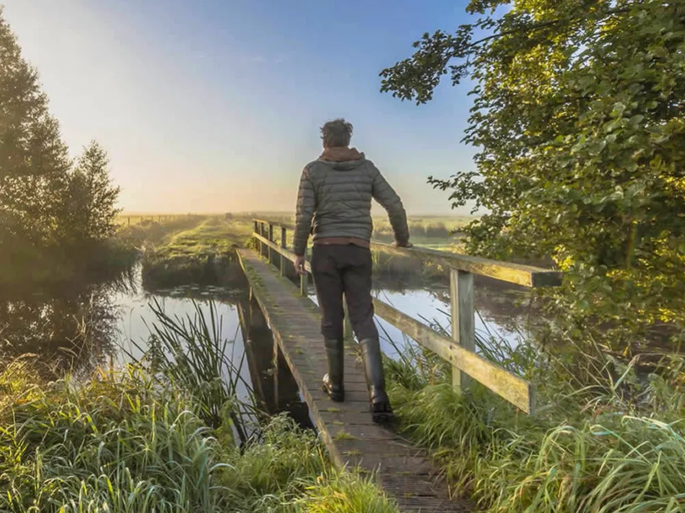 A man walking across a bridge