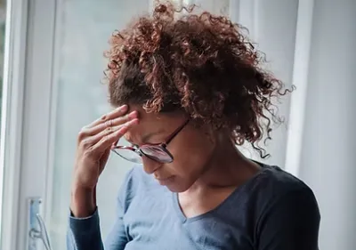 A woman with her head in her hands