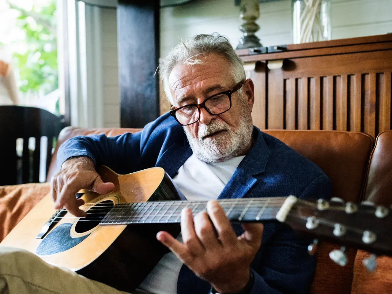 A man playing an accoustic guitar