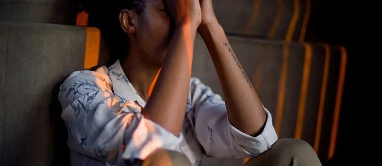 A person with their head in their hands